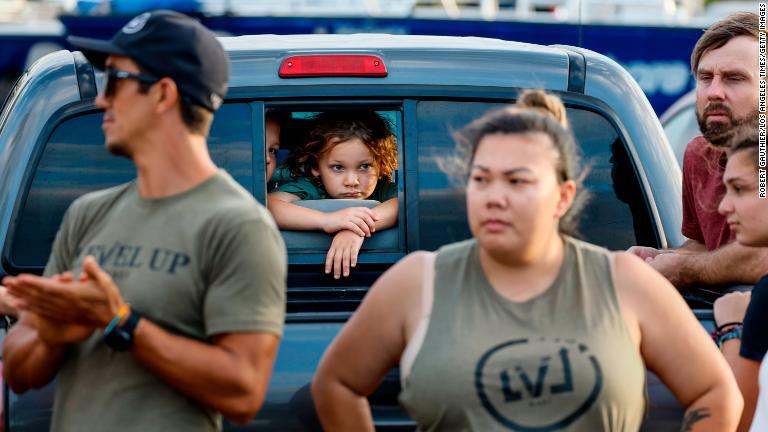 食料や支援物資を積んだトラックがラハイナへ向かうのを見つめるボランティア＝８月１０日/Robert Gauthier/Los Angeles Times/Getty Images