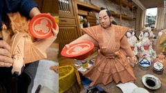 博多人形作りの名匠、武吉国明氏が働く福岡郊外の作業場。武士の人形に最後の仕上げを施しているところ