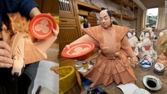 博多人形作りの名匠、武吉国明氏が働く福岡郊外の作業場。武士の人形に最後の仕上げを施しているところ