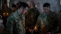 クリスマスイブのミサでキャンドルに火をつける米兵＝イラク