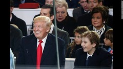 息子のバロン君とほほ笑むトランプ大統領。第５８回目の就任パレードを見ながら