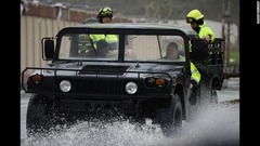 プエルトリコのウマカオで冠水した道路を車で走る救援隊