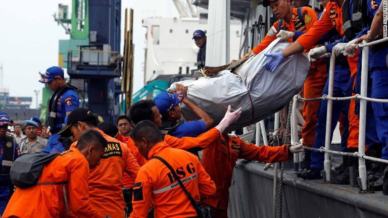 見つかった残骸を搬送する救急隊員＝３０日、ジャカルタ/Edgar Su/REUTERS
