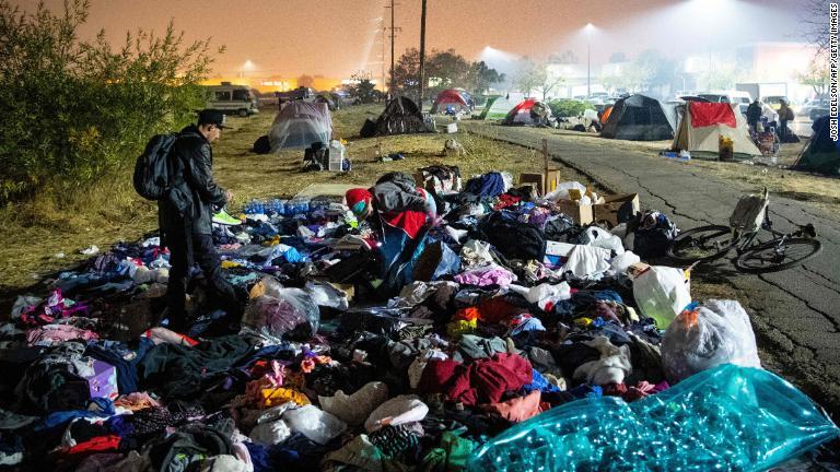 積み上げられた衣服の中を移動する避難してきた男性＝１７日、カリフォルニア州チコ/Josh Edelson/AFP/Getty Images