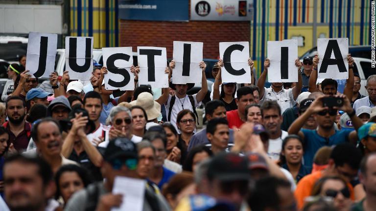 グアイド国会議長の集会で「正義」のプラカードを掲げる人たち＝１月２６日/Federico Parra/AFP/Getty Images