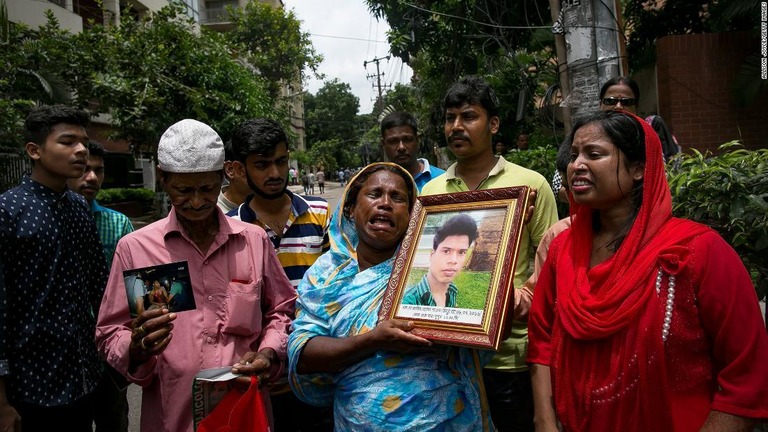 テロの犠牲となった息子の写真を手に涙を見せる母親/Allison Joyce/Getty Images