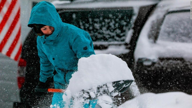 雪かきをする少年。デンバーでは３０センチ近い雪が積もった/Joe Mahoney/Getty Images