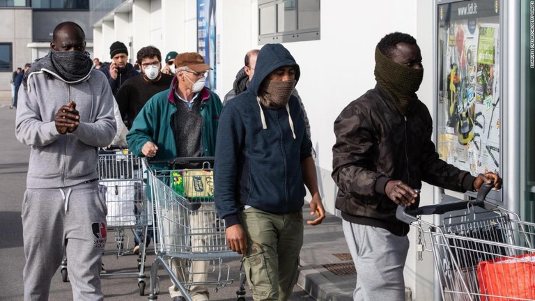 スーパーマーケットの前にはマスク姿の人たちが行列をつくった/Emanuele Cremaschi/Getty Images