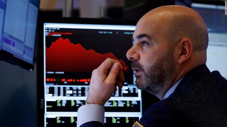 ニューヨーク証券取引所のフロアで画面を見つめるトレーダー/Richard Drew/AP