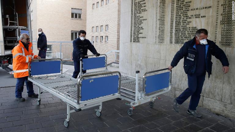 イタリア・コドーニョで病院に新しいベッドを運び込む病院職員。同病院では新型コロナウイルスの感染者を受け入れ＝２月２１日/Luca Bruno/AP