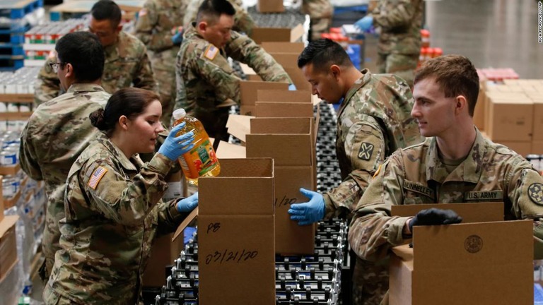 米加州のフードバンクで物資をさばく州兵の隊員ら/Rich Pedroncelli/AP