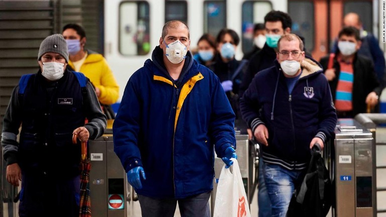 マスクを着用したスペインの労働者が地下鉄の改札を出る様子＝１３日、マドリード/Borja B. Hojas/Getty Images