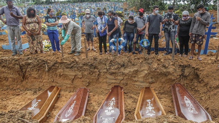 集団埋葬時にひつぎを見守る遺族＝１９日、マナウス/Andre Coelho/Getty Images