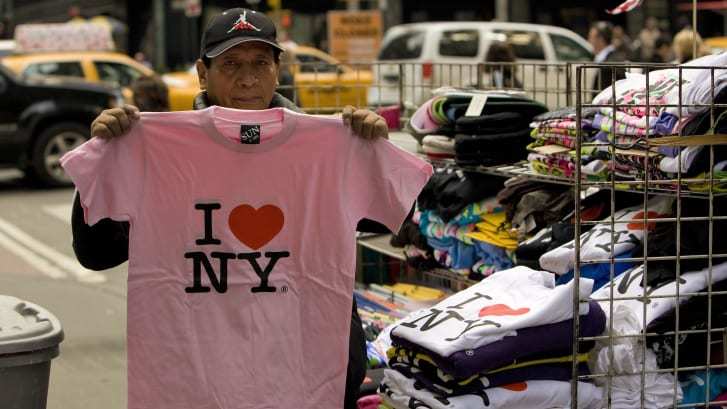 「Ｉ♥ＮＹ」のロゴ入りＴシャツを売る男性/George Rose/Getty Images