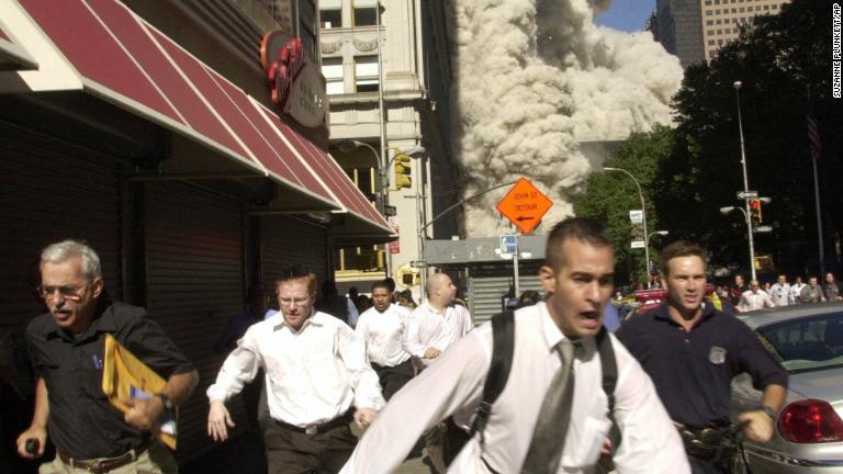 建物が倒壊するなか、逃げ出す人々/Suzanne Plunkett/AP