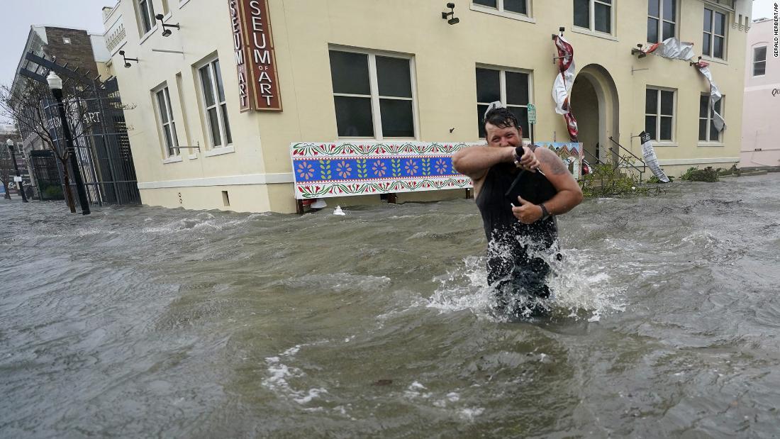 非難するため洪水の中をあるく住民＝１６日、米フロリダ州/Gerald Herbert/AP
