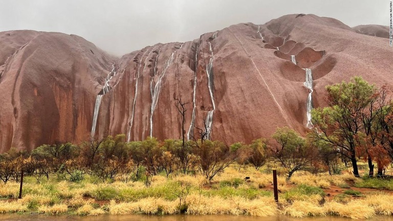 豪雨の後、ウルルの岩肌を滝のように水が流れ落ちる幻想的な風景が出現した/Stacey MacGregor/via Reuters