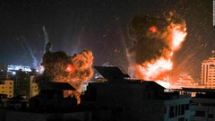 イスラエル軍の空爆を受けるガザ市の建物＝１８日未明