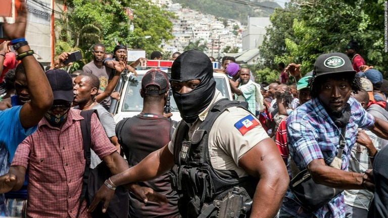 大統領暗殺に関与したとみられる容疑者を拘束した警察署の近くで歓声を上げる人々＝８日、ハイチ首都ポルトープランス/Valerie Baeriswyl/AFP/Getty Images