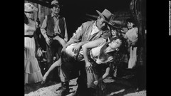 １９６３年のコメディー映画「マクリントック」のワンシーン。ジョン・ウェイン演じる主人公のジョージ・ワシントン・マクリントックがモーリン・オハラ演じる妻のキャサリンの尻を公衆の面前で叩いている