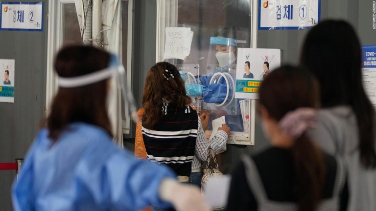 検査場の仮設ブースで医療従事者から新型コロナの検査を受ける人々＝７日、韓国・ソウル/Ahn Young-joon/AP