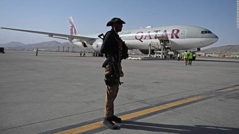 カブールの空港でカタール航空機の近くに立つカタールの治安要員＝９日/WAKIL KOHSAR/AFP/Getty Images
