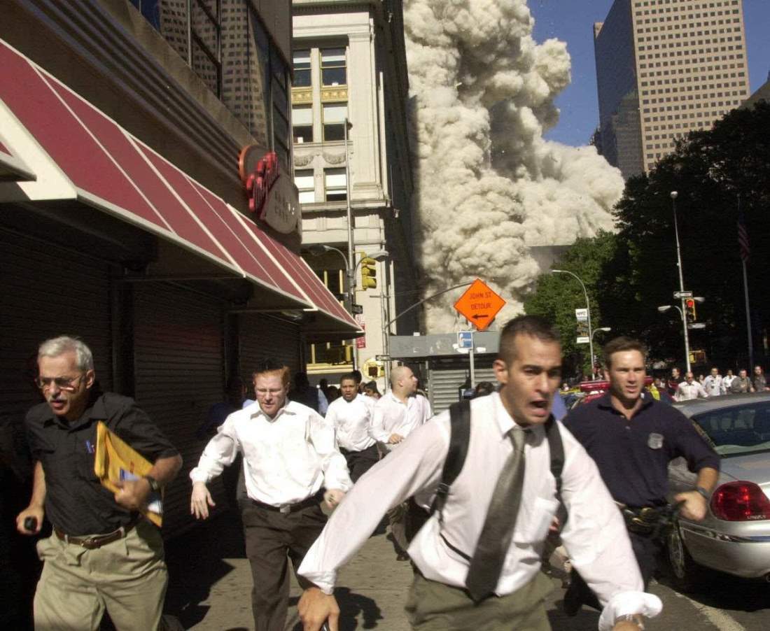 ニューヨークの世界貿易センタービルの１棟が崩壊し逃げる人々/Suzanne Plunkett/AP