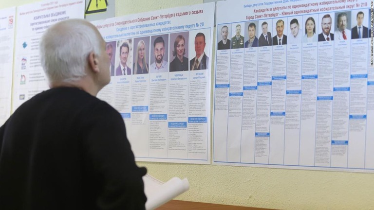 ３日間の選挙最終日に候補者の情報を眺める男性/Sergei Mikhailichenko/SOPA Image/Shutterstock