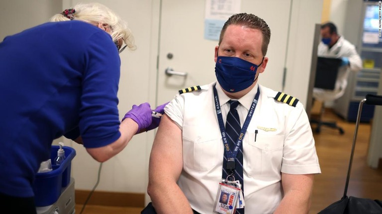新型コロナウイルスのワクチン接種を受けるユナイテッド航空の操縦士＝３月、米シカゴ・オヘア国際空港/Scott Olson/Getty Images