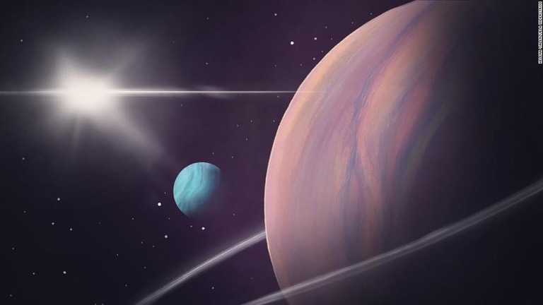 地球から５０００光年以上離れた巨大系外惑星（右）を周回する巨大天体（青色）が発見された/Helena Valenzuela Widerström