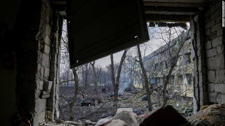 爆撃を受けた現地で作業に当たる緊急対応要員。ゼレンスキー大統領は「妊婦や子どもががれきの下にいる。残虐行為だ」と非難/Evgeniy Maloletka/AP