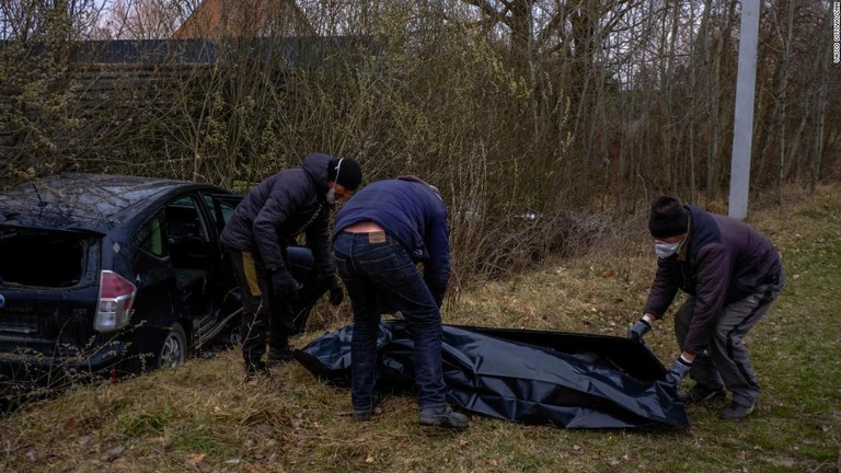 運転中に胸を撃ちぬかれ死亡した男性の遺体を回収するボランティアら/Vasco Cotovio/CNN
