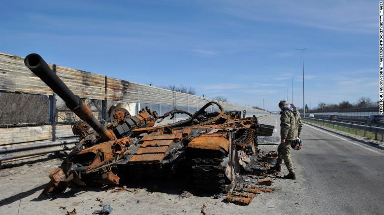 ウクライナ首都の西約40キロの地点で、破壊されたロシア軍の戦車を調べる男性/Sergei Chuzavkov/SOPA Images/LightRocket/Getty Images