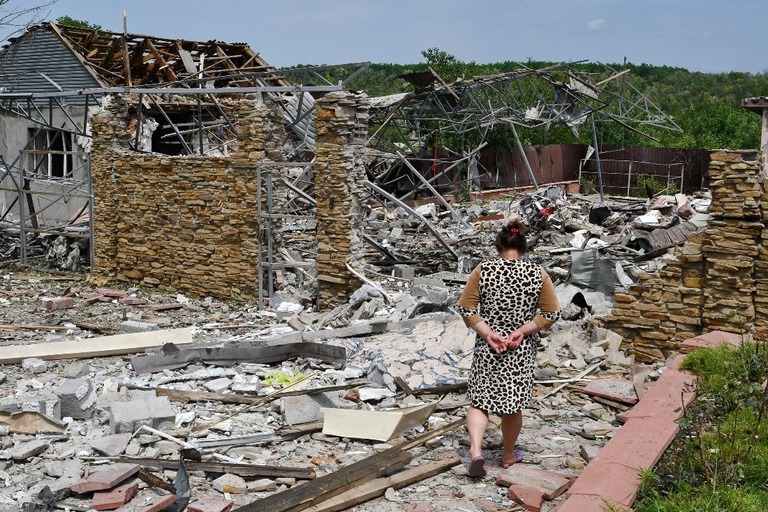 破壊された街を歩く女性＝１日、スラビャンスク/Andriy Andriyenko/AP