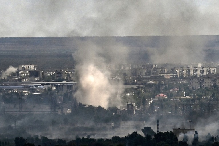砲撃による煙が立ち上るウクライナ東部ルハンスク州セベロドネツクの街並み/Aris Messinis/AFP/Getty Images