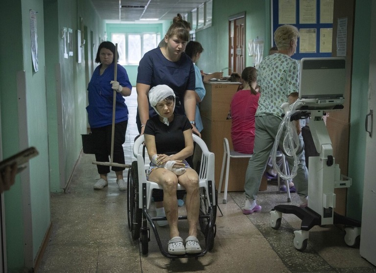 ウクライナのクレメンチュクにあるショッピングセンターでロシアのロケット攻撃により負傷した女性（写真中央）＝２８日/Efrem Lukatsky/AP