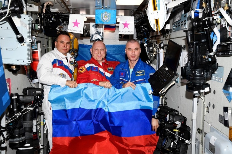 「ルガンスク人民共和国（ＬＰＲ）」の旗を手にしてポーズをとるロシア人飛行士/Roscosmos/Reuter