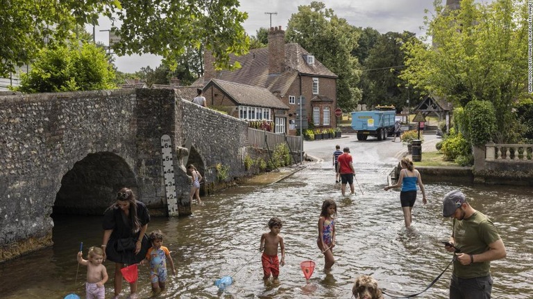 川に入り涼を求める人々＝１２日、英アインスフォードのダレント川/Dan Kitwood/Getty Images Europe/Getty Images