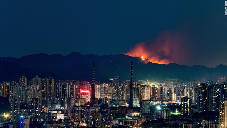 大都市重慶の背後の山々で火災が発生。炎と煙が空に立ち上る/VCG/Getty Images