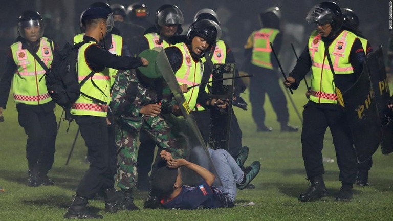 試合後のピッチに乱入したファンを拘束する警官と兵士/Yudha Prabowo/AP