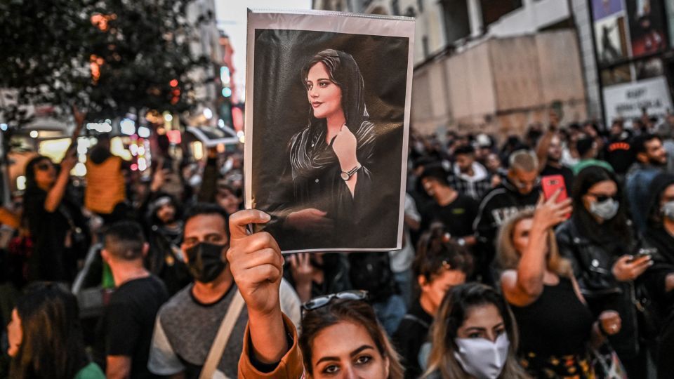 死亡したイラン人女性、マフサ・アミニさんの肖像を掲げるデモ参加者＝トルコ・イスタンブール、９月２０日撮影