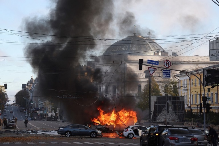 キーウ中心部への軍事攻撃後に燃える車両＝１０日/Gleb Garanich/Reuters