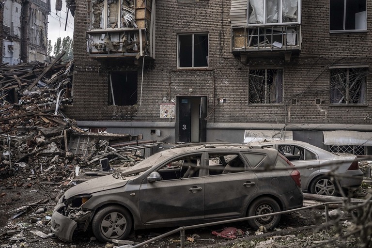 ロシアのミサイル攻撃後に損傷した車や建物を撮影＝１０日、ザポリージャ/Jose Colon/Anadolu Agency/Getty Images