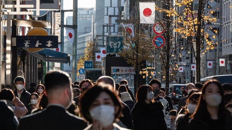 日本の国旗が飾られた銀座の目抜き通りを歩く人々＝昨年１２月２９日撮影/Richard A. Brooks/AFP/Getty Images