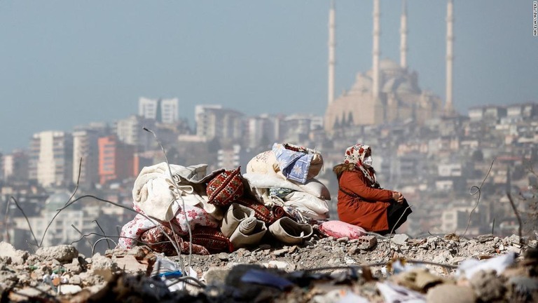 自宅のがれきの上に座る女性＝２月１４日、トルコ南部カフラマンマラシュ/Nir Elias/Reuters