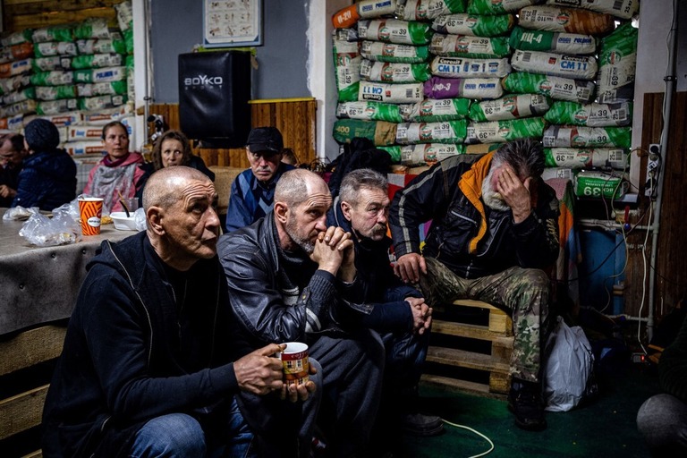 人道援助センターでテレビを見るウクライナの人々＝２月２７日、ウクライナ東部バフムート/Dimitar Dilkoff/AFP/Getty Images