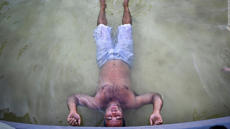 ブエノスアイレス市内の噴水で涼を取る男性＝８日/Luis Robayo/AFP/Getty Images