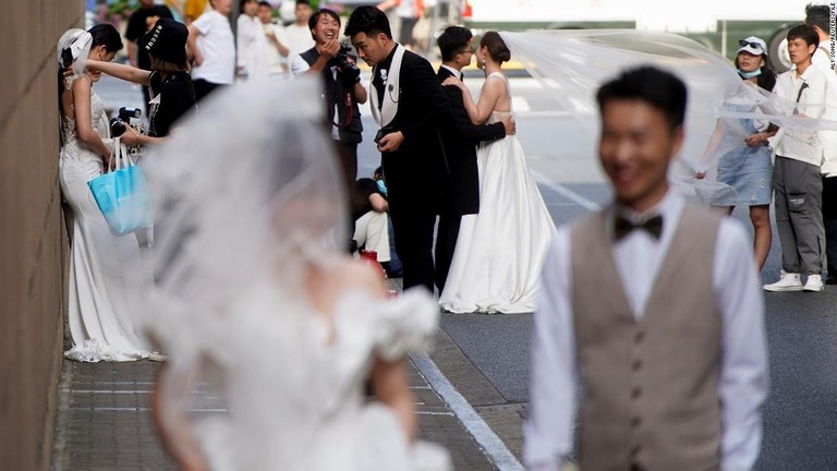 上海の街路で結婚式の記念写真を撮る準備をするカップルら/Aly Song/Reuters/File