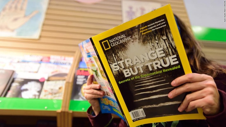米オレゴン州ポートランドの書店でナショナル・ジオグラフィックを読む女性/Alex Milan Tracy/Sipa/AP