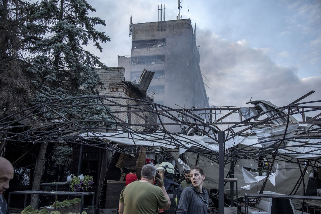 攻撃を受けたレストランのがれき周辺を歩く人/Narciso Contreras/Anadolu Agency/Getty Images